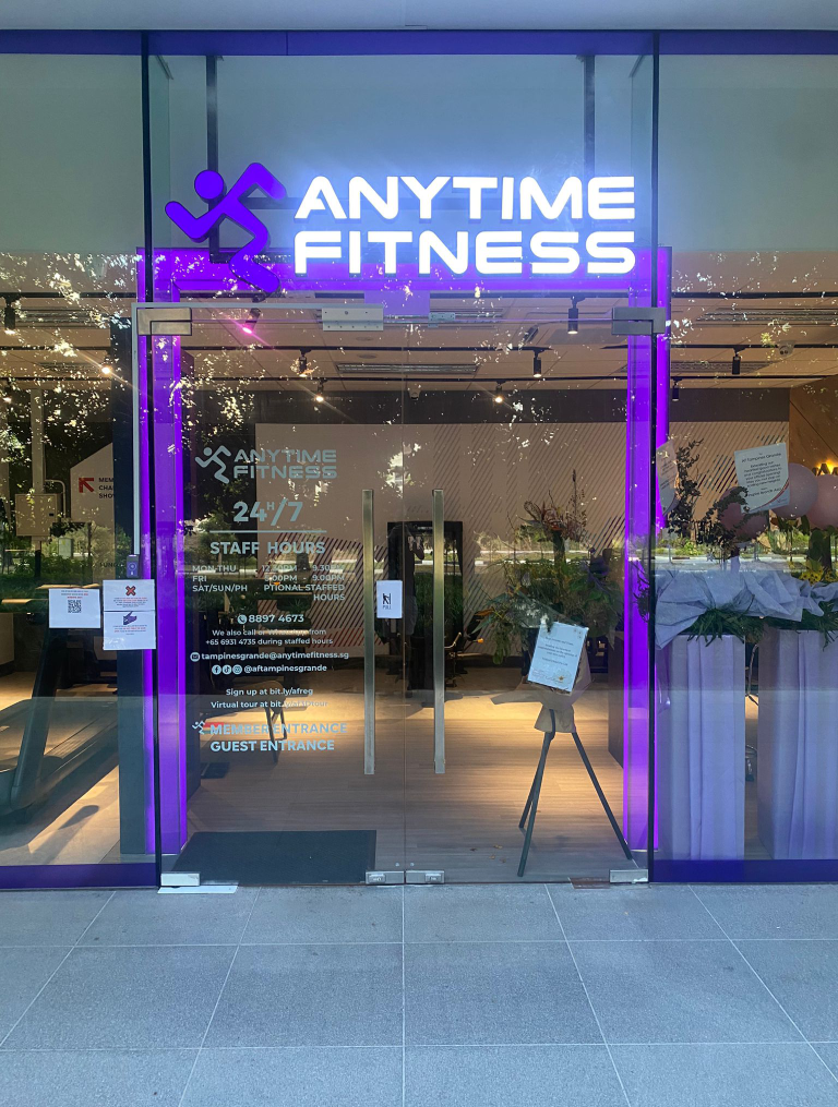 Anytime Fitness gym entrance fit-out by Trident Fitout, glass doors with staffed hours signage at the Tampines Grande outlet