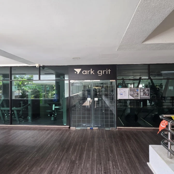 ark move gym fit-out by Trident Fitout, branded weight plates and dumbbell rack beneath a neon sign reading This Is My Happy Hour