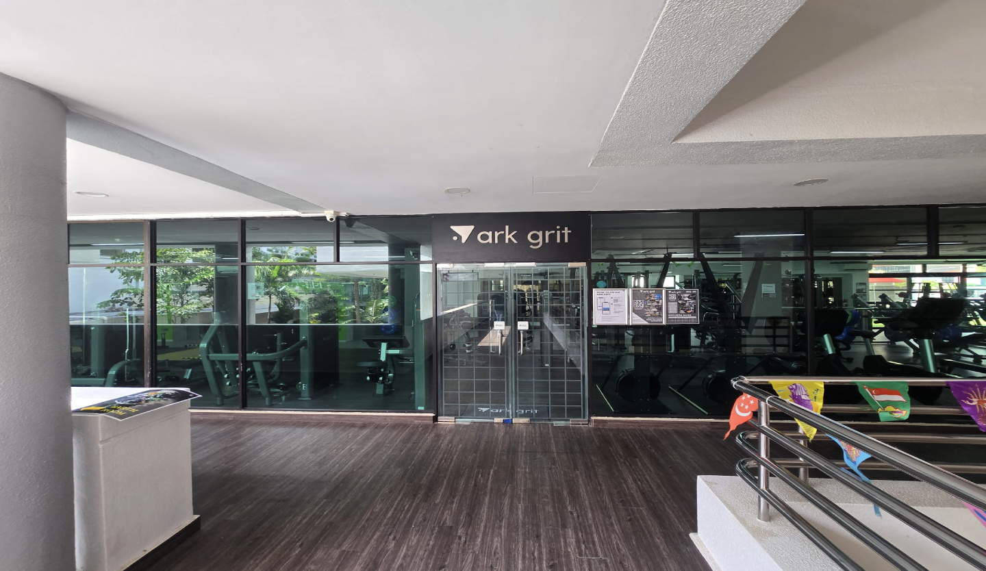 ark move gym fit-out by Trident Fitout, branded weight plates and dumbbell rack beneath a neon sign reading This Is My Happy Hour