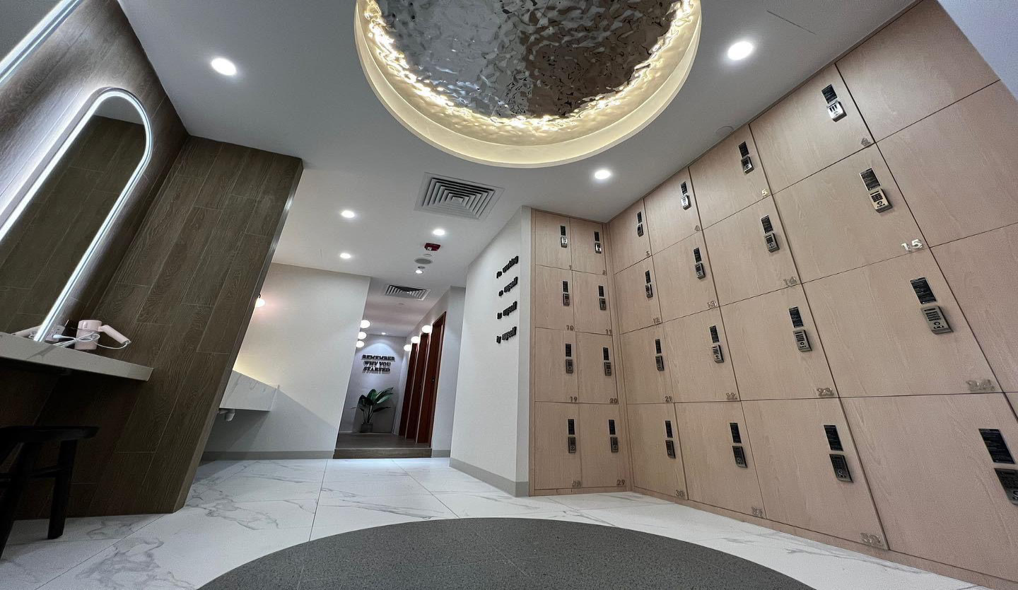 ark grit gym fit-out by Trident Fitout, training floor equipment along a glass wall overlooking greenery, with the ark grit sign above the entrance