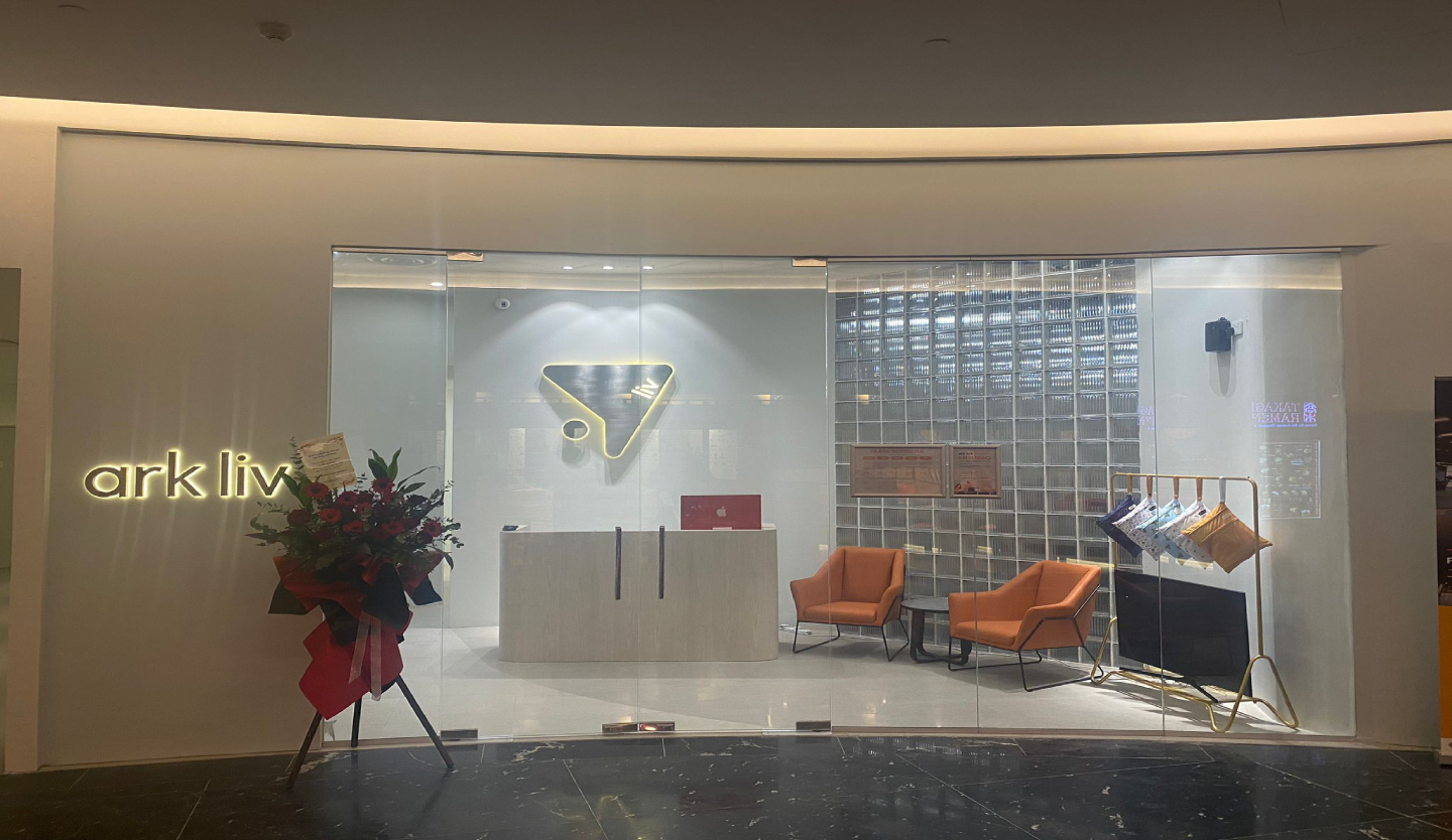 ark liv reception fit-out by Trident Fitout, timber counter beside a glass block feature wall and an arched alcove with motivational wall text