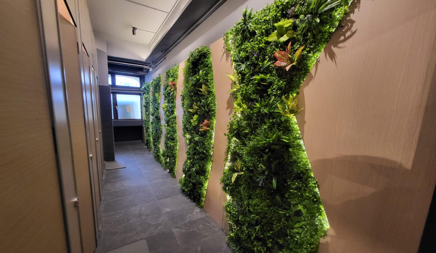 Body Fit Training washroom corridor fit-out by Trident Fitout, plant wall panelling leading to the vanity area
