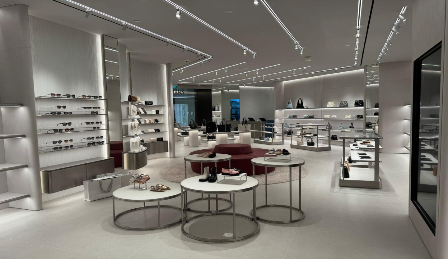 Charles & Keith retail store fit-out by Trident Fitout, circular display tables and shelving for shoes, bags and accessories