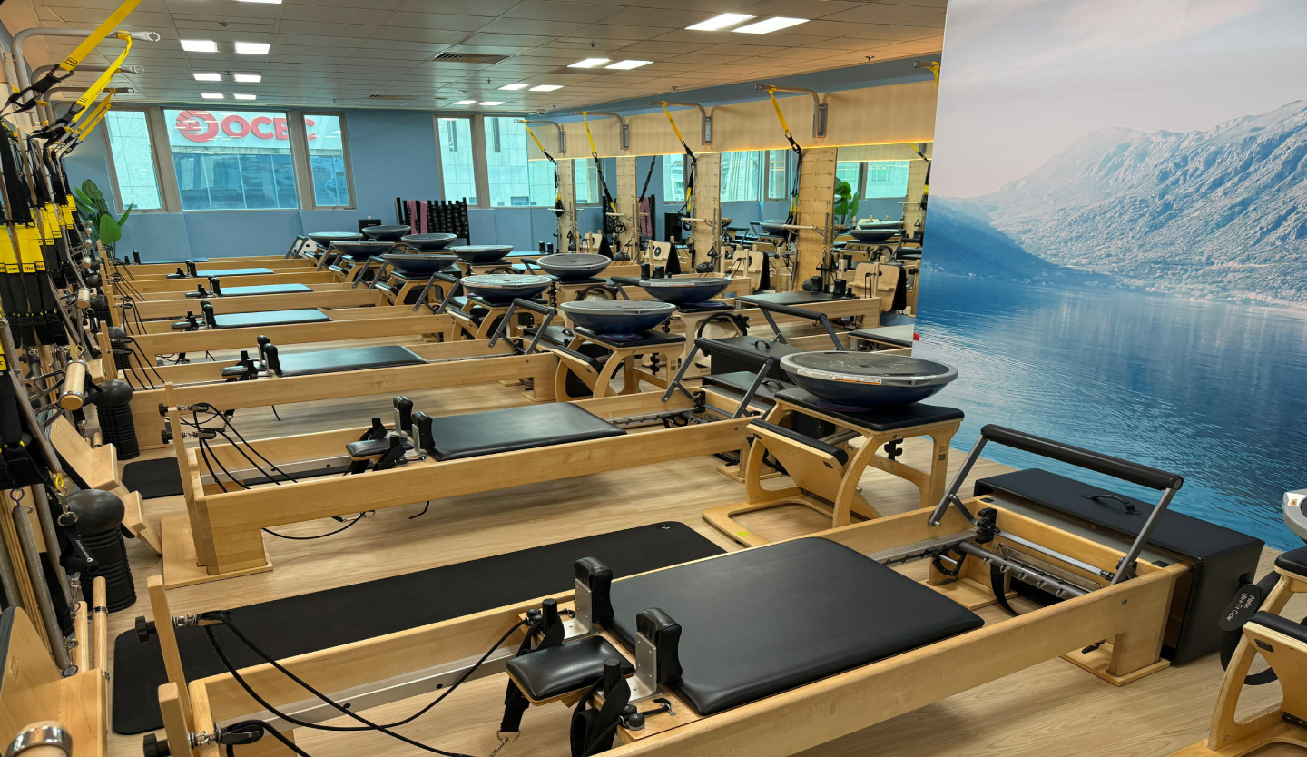 Club Pilates reformer studio fit-out by Trident Fitout, rows of reformer machines facing a scenic mural wall
