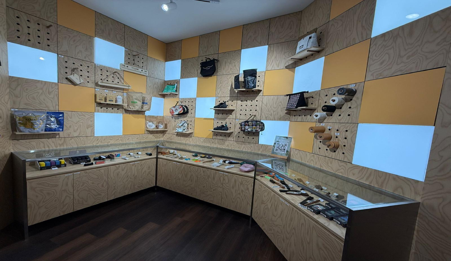 Fitbloc retail display fit-out by Trident Fitout, checkerboard pegboard wall and glass counters showing climbing gear and accessories